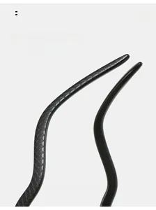 Macro detail of cat eye sunglasses featuring snake scale texture and curved temples