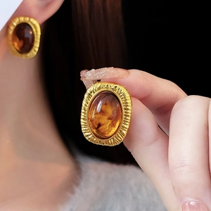 Vintage geometric gold earrings with amber resin stones and textured metal details