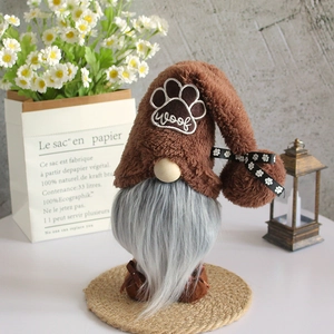 Standing dog-themed gnome plush with brown woof hat and grey beard on a jute mat