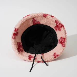Pink lamb wool bucket hat with red jacquard floral pattern and adjustable drawstring