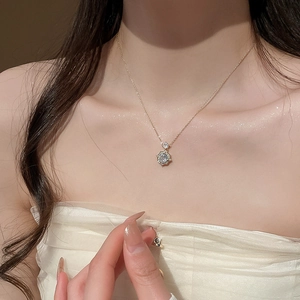 Close-up of 14k gold plated rose pendant necklace with zircons on model neck