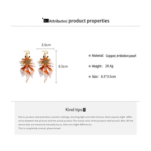 Detail showing dimensions of vintage goldfish pearl earrings with copper material