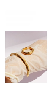 Detailed view of gold plated ribbed snake bone ring and matching bracelet set