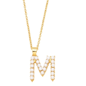 Detail shot of the golden letter M necklace pendant featuring small white pearls inlay