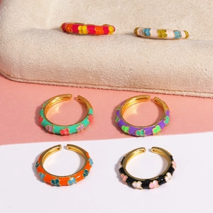 Detailed view of six colorful enamel butterfly rings in various vibrant finishes