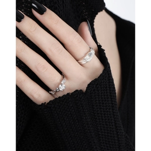 Textured S925 silver rings with zircons on model hand in black sweater