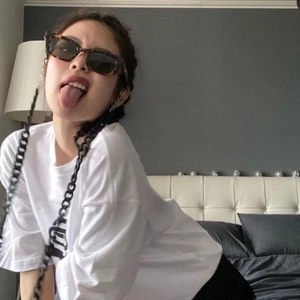 Vintage tortoiseshell narrow frame sunglasses with black lenses worn by a fashion model