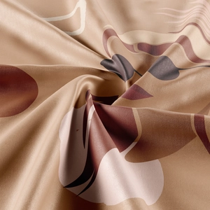 Macro shot showing the smooth satin texture and elegant floral print of this bohemian tapestry