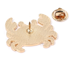 Golden crab enamel pin badge with textured metal finish and secure butterfly clutch