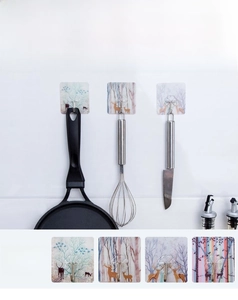 Strong adhesive wall hook with forest elk print holding heavy kitchen pans and tools
