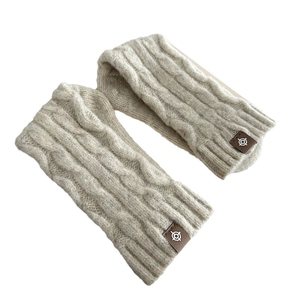Winter chunky knit beige wool arm warmers with cable pattern and leather logo tag