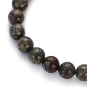 Macro shot of colorful natural gemstone beads showing unakite textures and polished finish