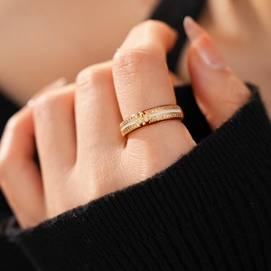 Close-up of 18k gold plated ring with fleur-de-lis motif and sparkling zircon stones
