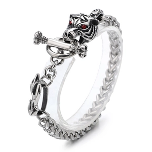 Retro wolf head titanium steel bracelet with red gem eyes and toggle clasp on white background