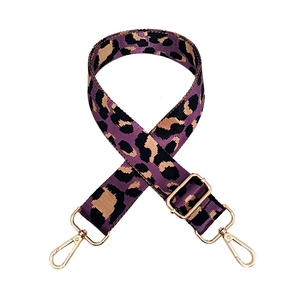 Detail of adjustable leopard print bag strap in purple and black with gold metal hooks