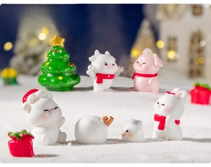 Miniature Christmas resin figurines of animals and tree on a snowy DIY landscape setup