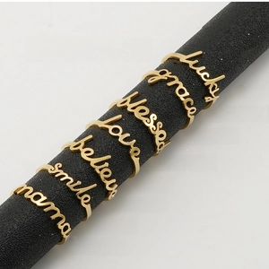 Detailed close-up of 18K gold-plated adjustable rings with hollow letter motifs