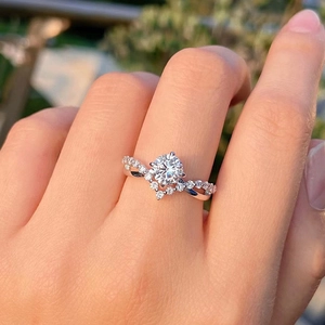 Exquisite silver engagement ring with crown-style four-prong diamond on twisted band