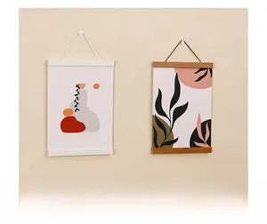 Detail of wooden magnetic poster frames with abstract art hanging on a neutral wall