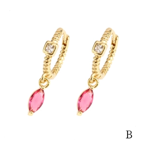 Detail view of 18K gold earrings with square zircon and pink marquise cut stone drop