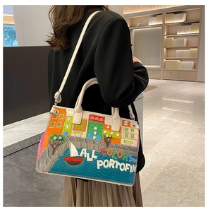 Detail of embroidered Mediterranean landscape on high-quality textured leather handbag