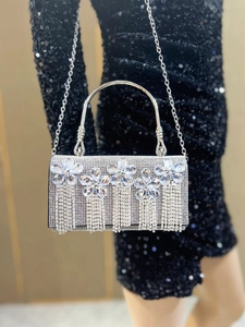 Detail of silver evening bag with five crystal flowers and long rhinestone tassels