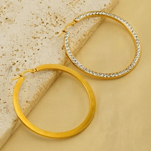 18k gold plated stainless steel hoop earrings with crystals on textured stone background