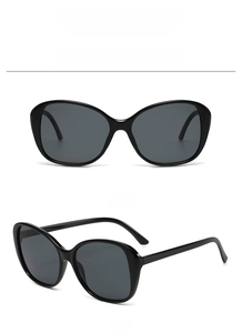 Front and 45-degree side view of oversized black butterfly sunglasses with high-gloss finish