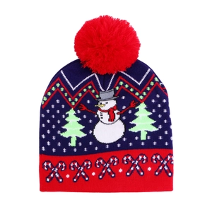 Detailed knit pattern of a navy Christmas beanie featuring snowman and candy cane motifs