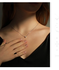 Close-up of S925 sterling silver heart necklace with micro-pave stones on woman neck
