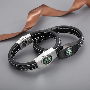 Close-up of braided leather survival bracelets with compass and stainless steel buckles