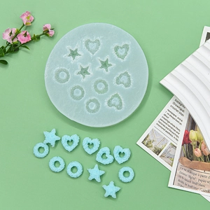 Light blue silicone mold for candy donuts and heart shapes on fresh green background