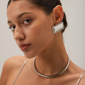 Polished silver rectangular earrings with crystals worn by a model with a metal choker