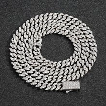 Close-up of silver-tone iced out Cuban link chain necklace with sparkling crystals