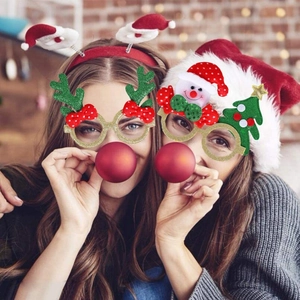Women wearing Christmas glitter glasses with reindeer antlers and festive headbands