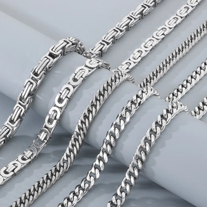 Silver punk Cuban and Byzantine link waist chains displayed on gray minimalist props