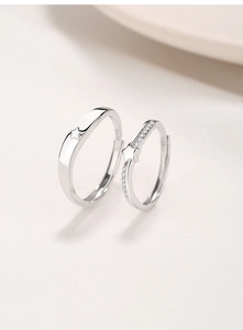 Detail view of S925 sterling silver couple rings with star pattern and zircon pavé set