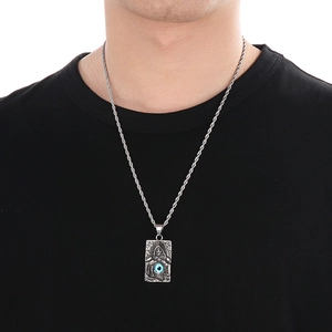 Detailed shot of silver grim reaper pendant with blue evil eye charm on rope chain