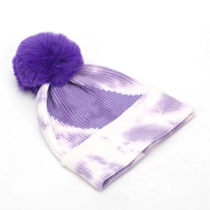 Chic purple tie-dye knit beanie for women featuring a large faux fur pom-pom topper