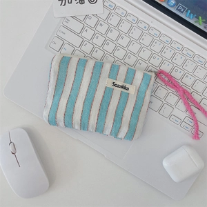 Detail of blue and white striped canvas pouch with red stitching and Sozakka label