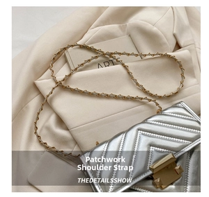 Detail of silver chevron quilted bag with gold hardware and spliced shoulder strap