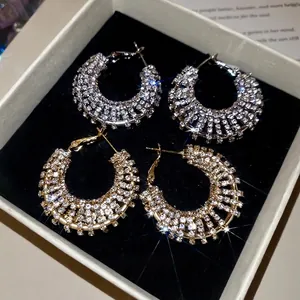 Elegant gold and silver pavé crystal hoop earrings in a luxury jewelry gift box