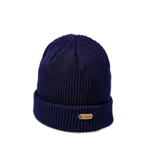 Detail of navy knit beanie showing thick ribbed texture and classic deer leather patch