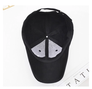 Internal view of black cotton baseball cap showing white mesh support and adjustable buckle