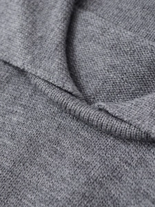 Detail of grey knitted sweater neckline with premium ribbed knit and soft wool texture