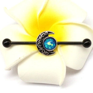 Black industrial barbell piercing with silver crescent moon and blue opal stone