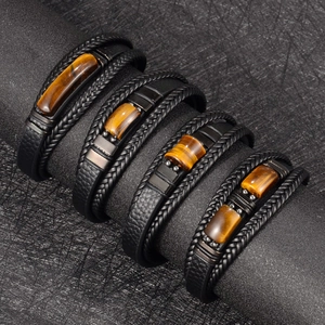 Detail view of multi-layer black leather bracelets with natural tiger eye stones and magnetic clasp