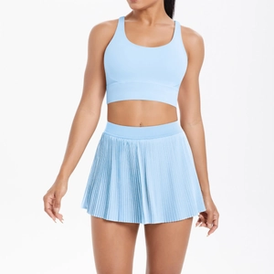 Detail of light blue cross back sports bra and pleated tennis skirt set for fitness