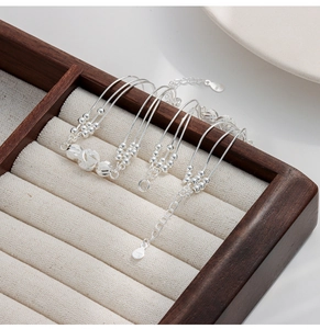 Macro detail of S925 sterling silver multilayer bracelet with frosted and polished beads