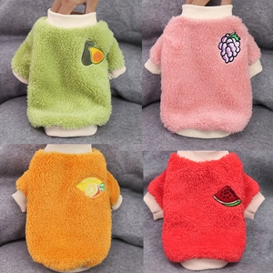 Detail showing four colors of plush dog sweaters with cute fruit embroidery designs